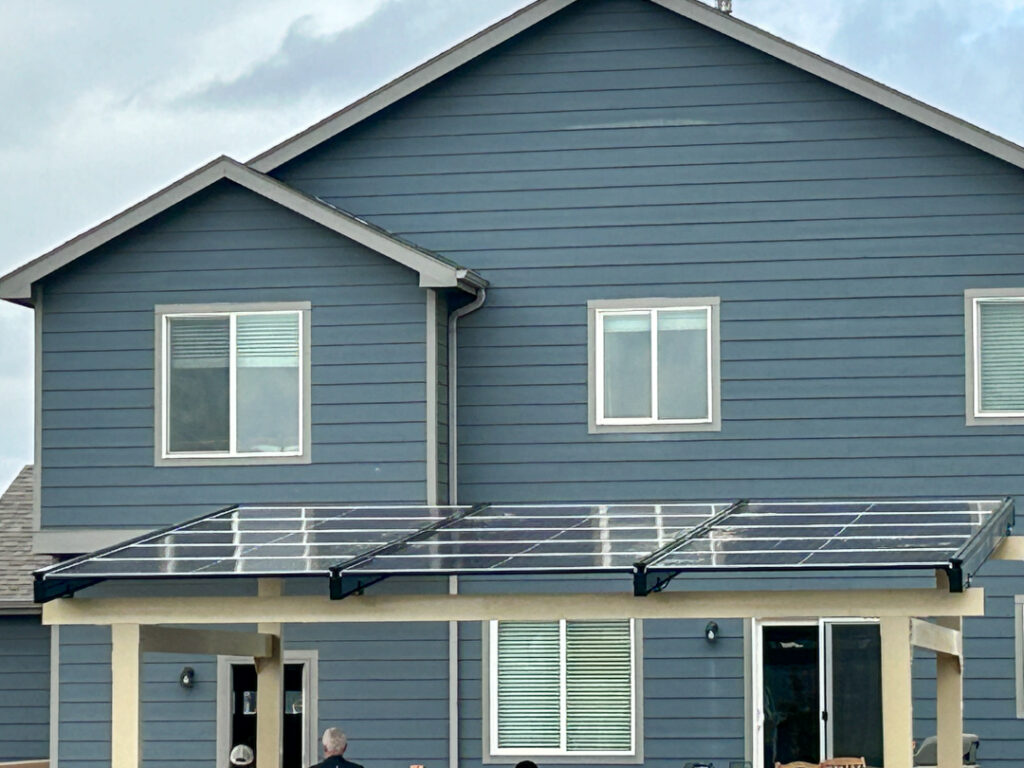 Backyard solar pergola providing shade and renewable energy generation