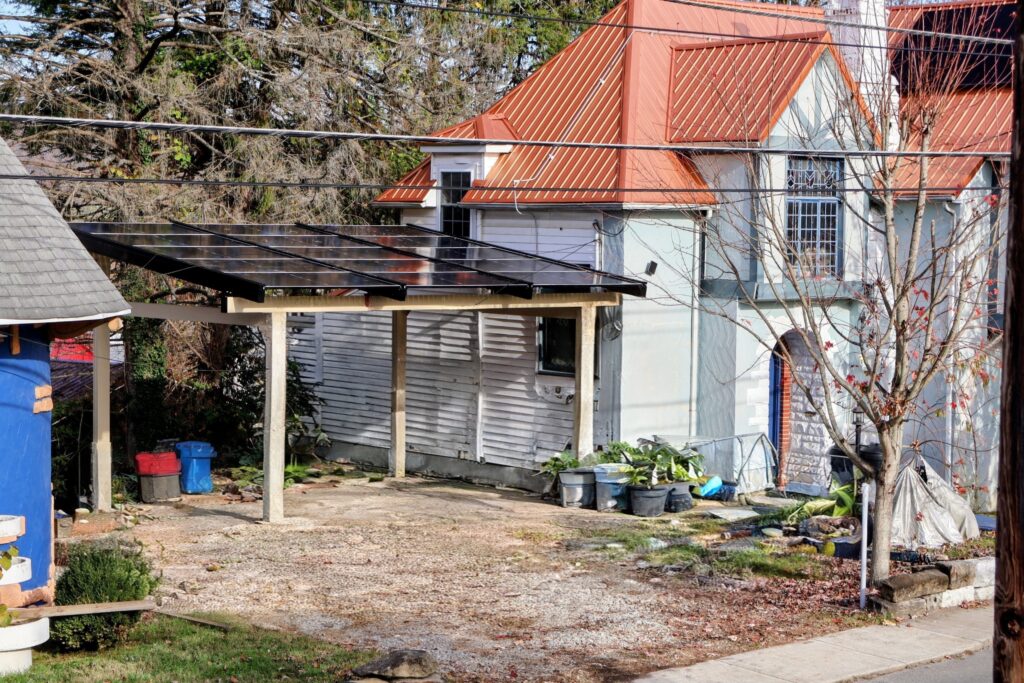 Solar carport providing covered parking while complementing a historic home