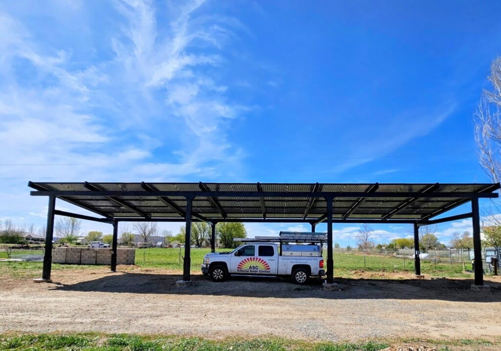 Solar carport installed on a working farm in rural Colorado protecting equipment from weather
