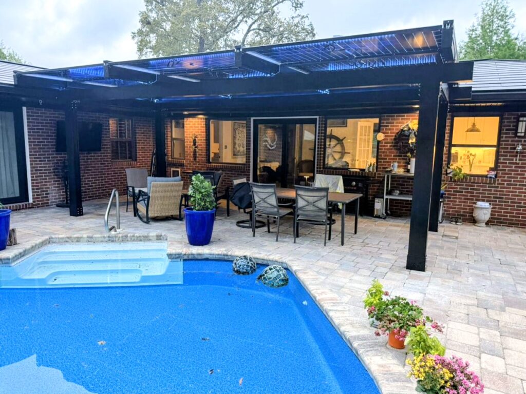 Solar pergola installed beside a residential swimming pool in Florida
